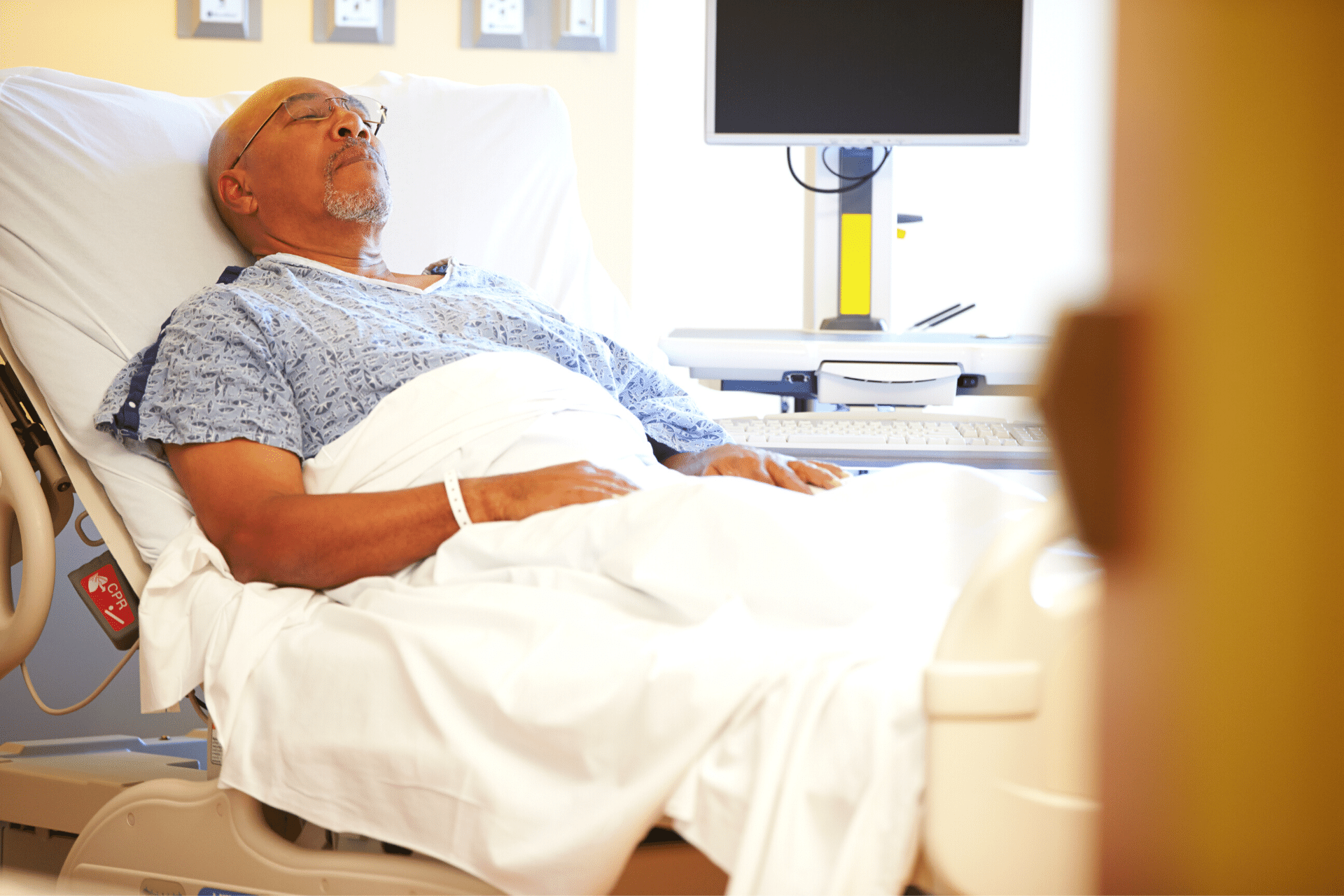 An elderly man in a hospital bed.